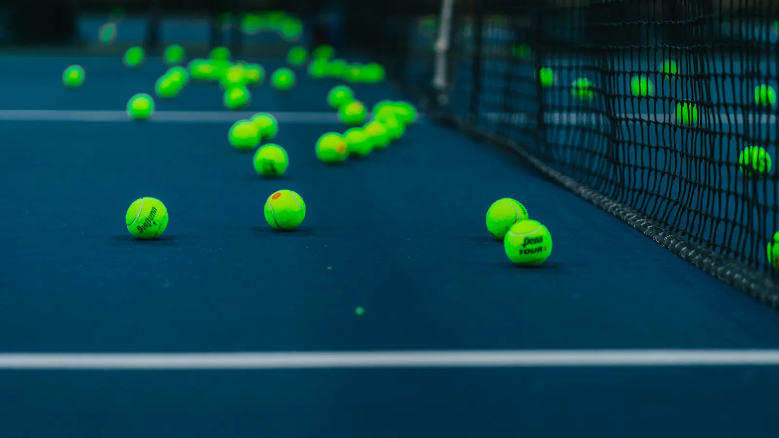 Padel balls scattered by the net