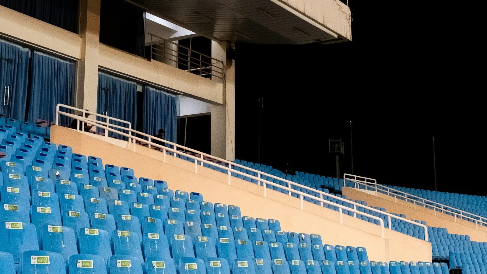 Rows of empty blue stadium seats