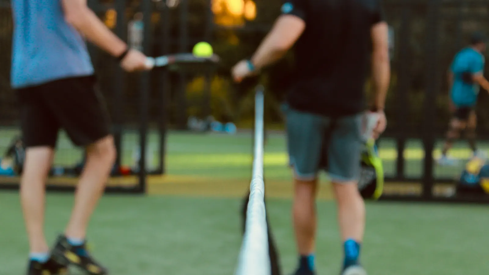 Two players meeting at the net during a social game