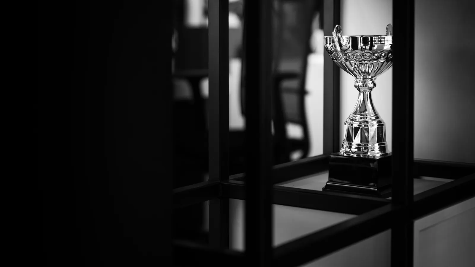 A silver cup in a dark room